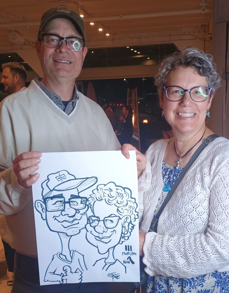 Wedding guests enjoying caricature entertainment by Björn